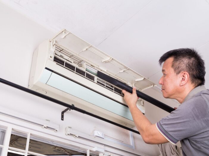 Technician Replacing an Air Conditioning Unit