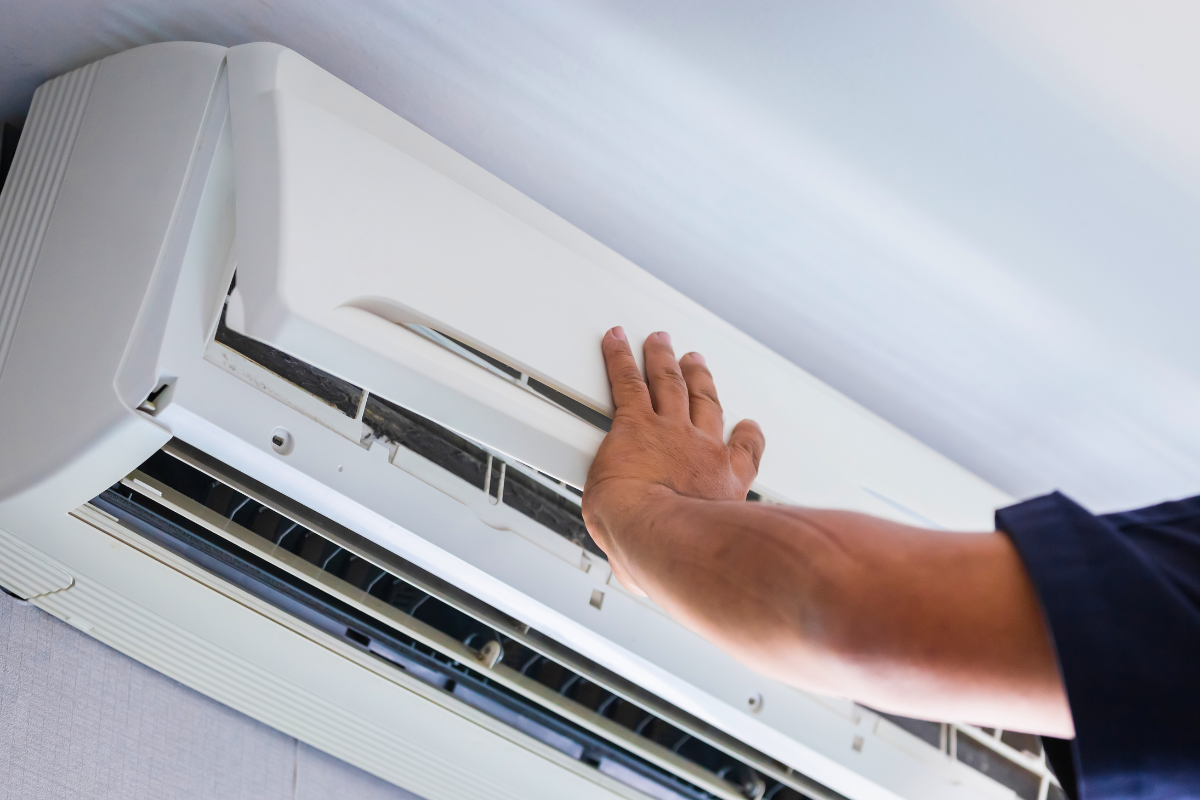 Technician repairing an AC Unit